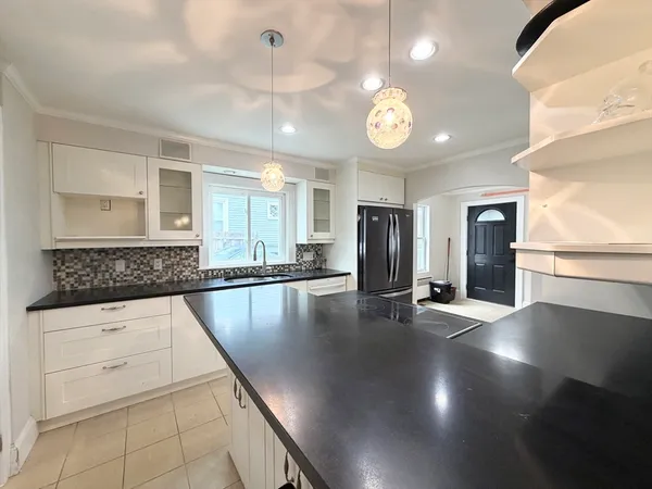 a kitchen with stainless steel appliances granite countertop a sink a oven and a large window
