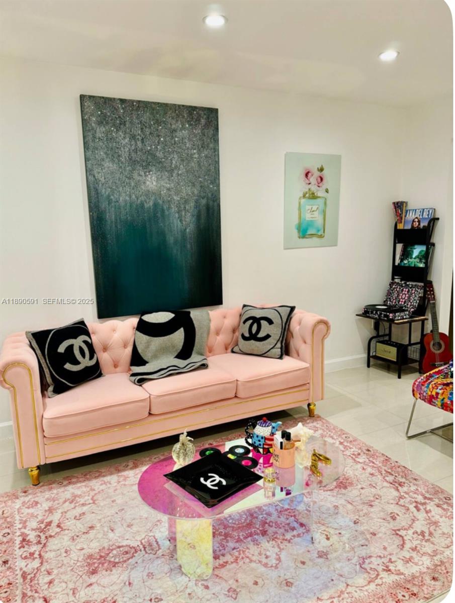 9240 Byron Avenue Surfside, FL 33154 - Photo 11 of 27 a living room with furniture and flowers