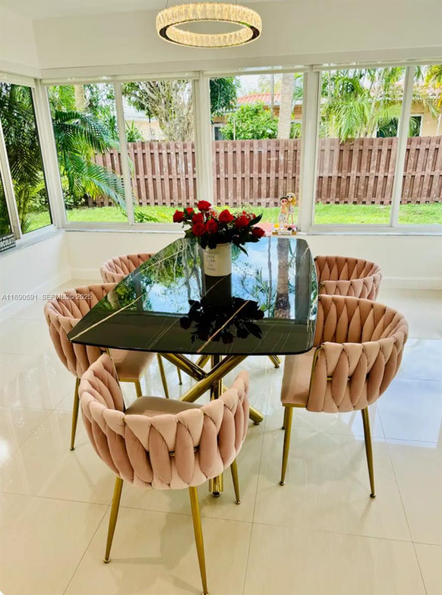 9240 Byron Avenue Surfside, FL 33154 - Photo 14 of 27 a view of a chairs and table in the patio