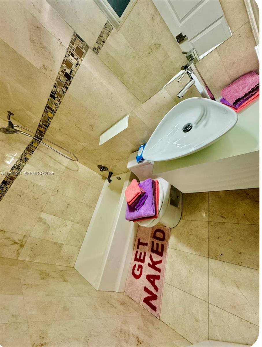 9240 Byron Avenue Surfside, FL 33154 - Photo 17 of 27 a view of a indoor shower