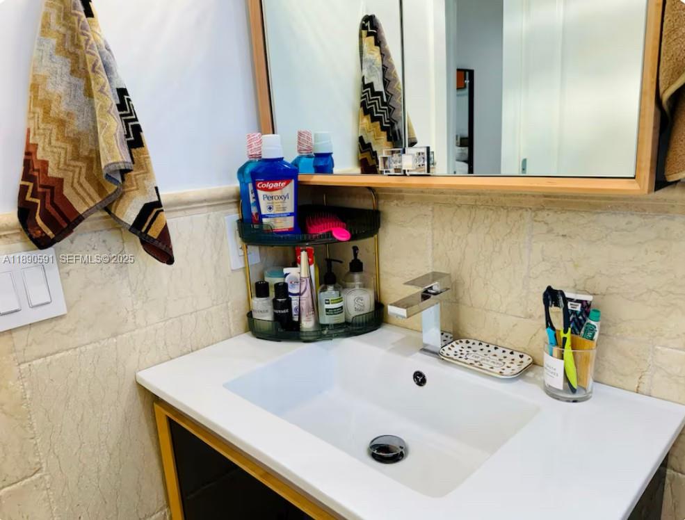 9240 Byron Avenue Surfside, FL 33154 - Photo 18 of 27 a bathroom with a sink and a mirror