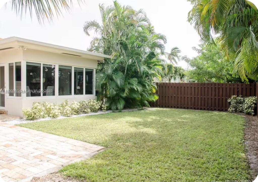 9240 Byron Avenue Surfside, FL 33154 - Photo 19 of 27 front view of a house with a yard
