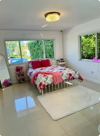 a kitchen with a table chairs sink and cabinets