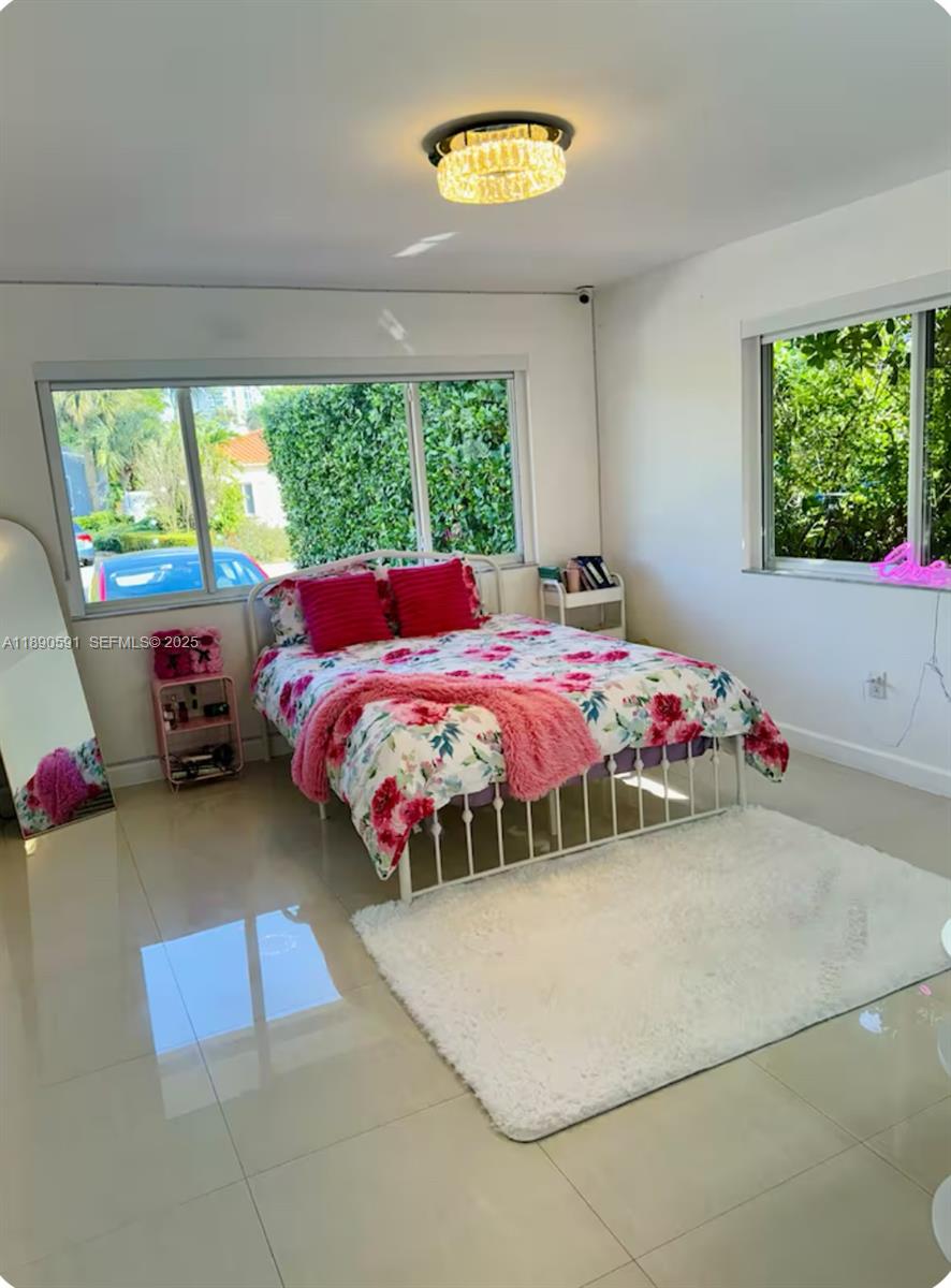 9240 Byron Avenue Surfside, FL 33154 - Photo 22 of 27 a bedroom with a bed and a window