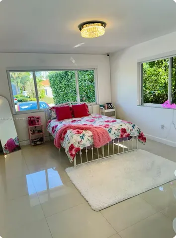 a kitchen with a table chairs sink and cabinets
