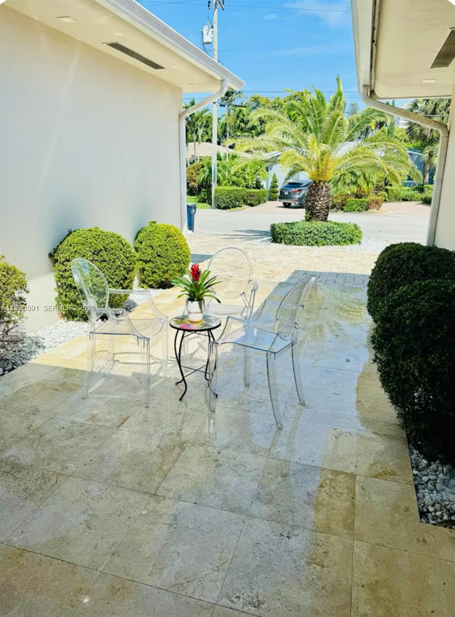 9240 Byron Avenue Surfside, FL 33154 - Photo 24 of 27 a view of a backyard with plants and a garden