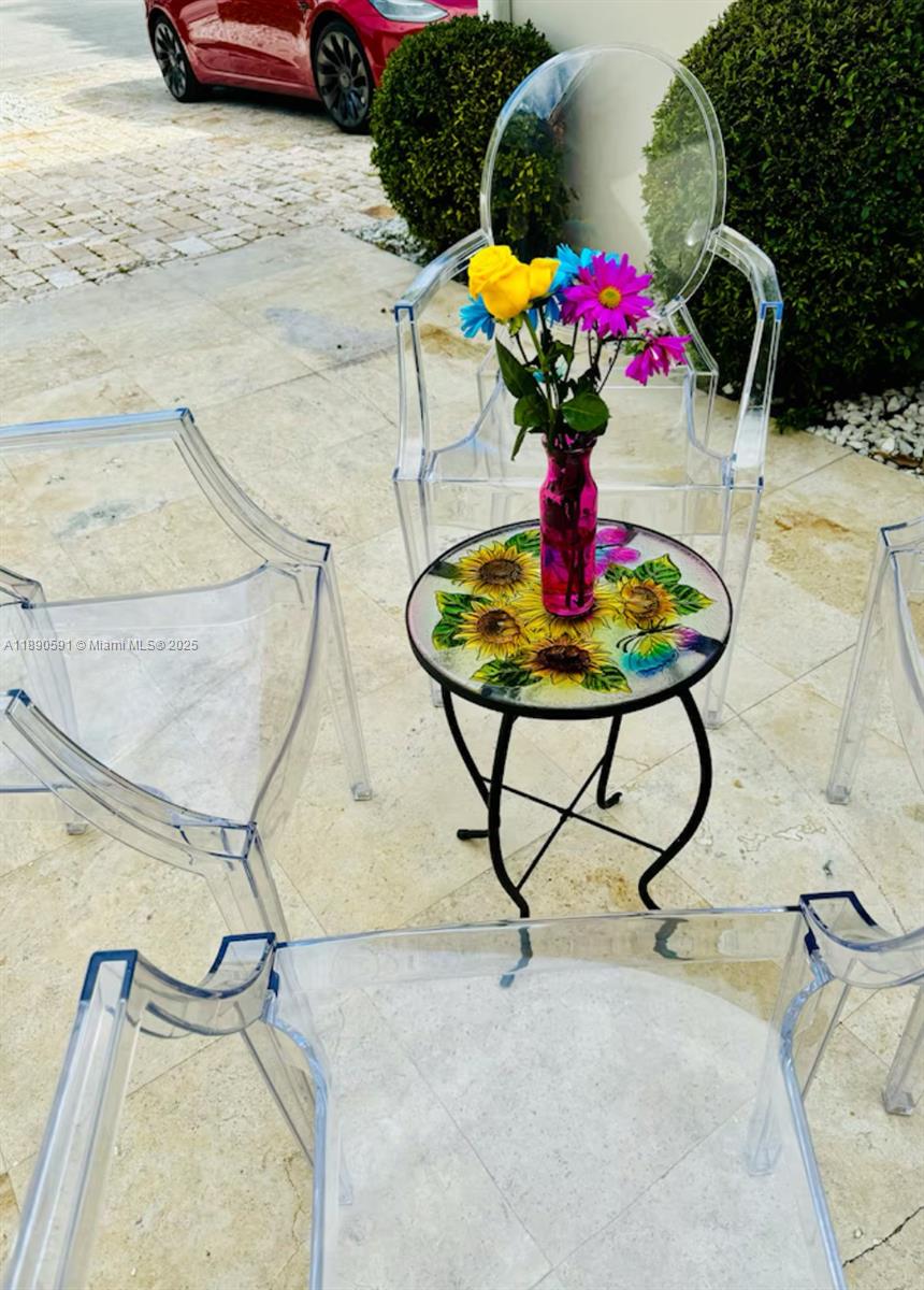 9240 Byron Avenue Surfside, FL 33154 - Photo 9 of 27 a vase of flowers sitting on a table