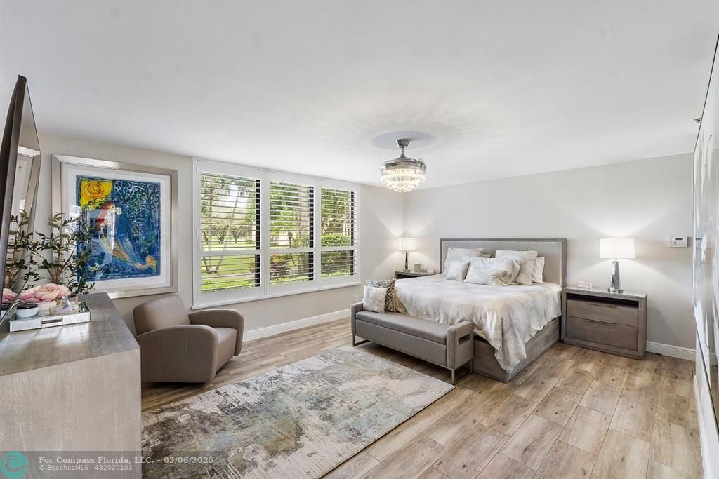 7225 Promenade Drive, Unit 102 Boca Raton, FL 33433 - Photo 1 of 67 a spacious bedroom with a bed and a couch
