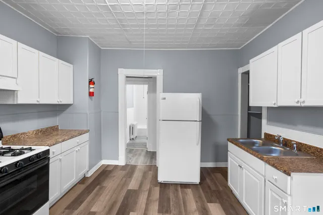 a kitchen with a sink stove and refrigerator