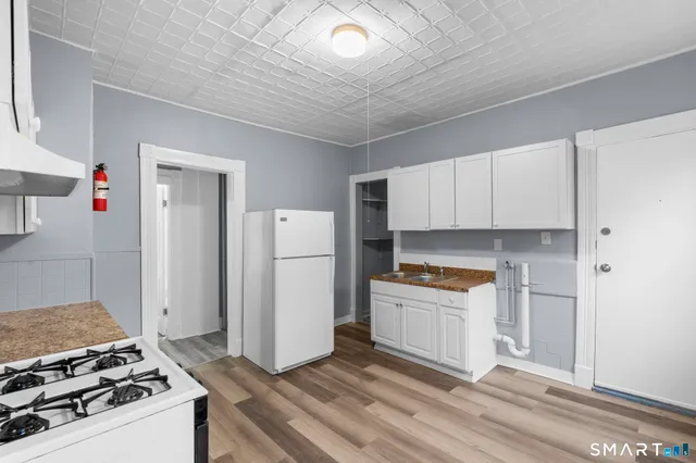 a kitchen with a stove and a refrigerator