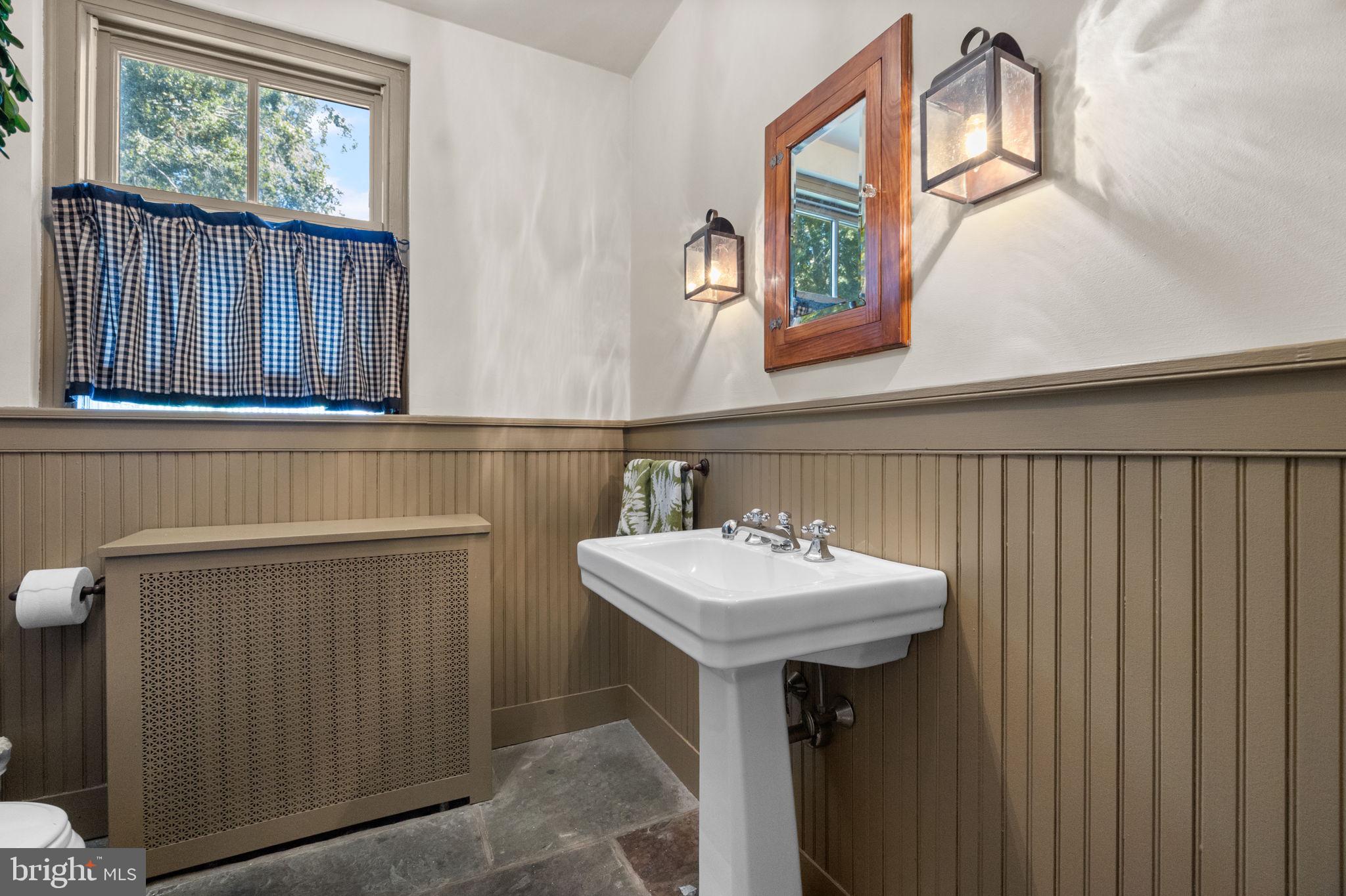 411 East Mill Road Flourtown, PA 19031 - Photo 19 of 62 a bathroom with a sink a mirror and a window