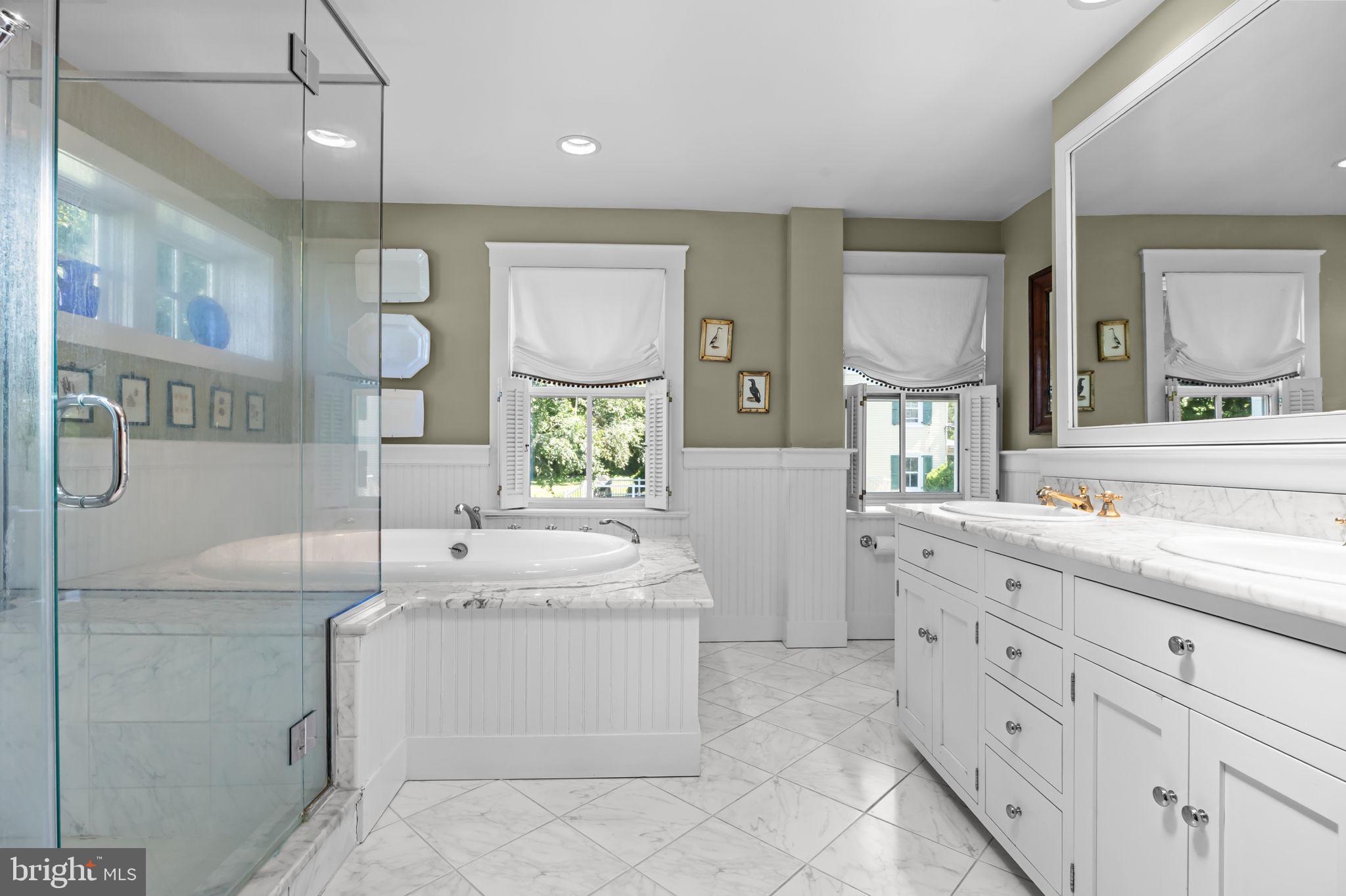 411 East Mill Road Flourtown, PA 19031 - Photo 36 of 62 a bathroom with a sink a vanity a mirror and a bathtub