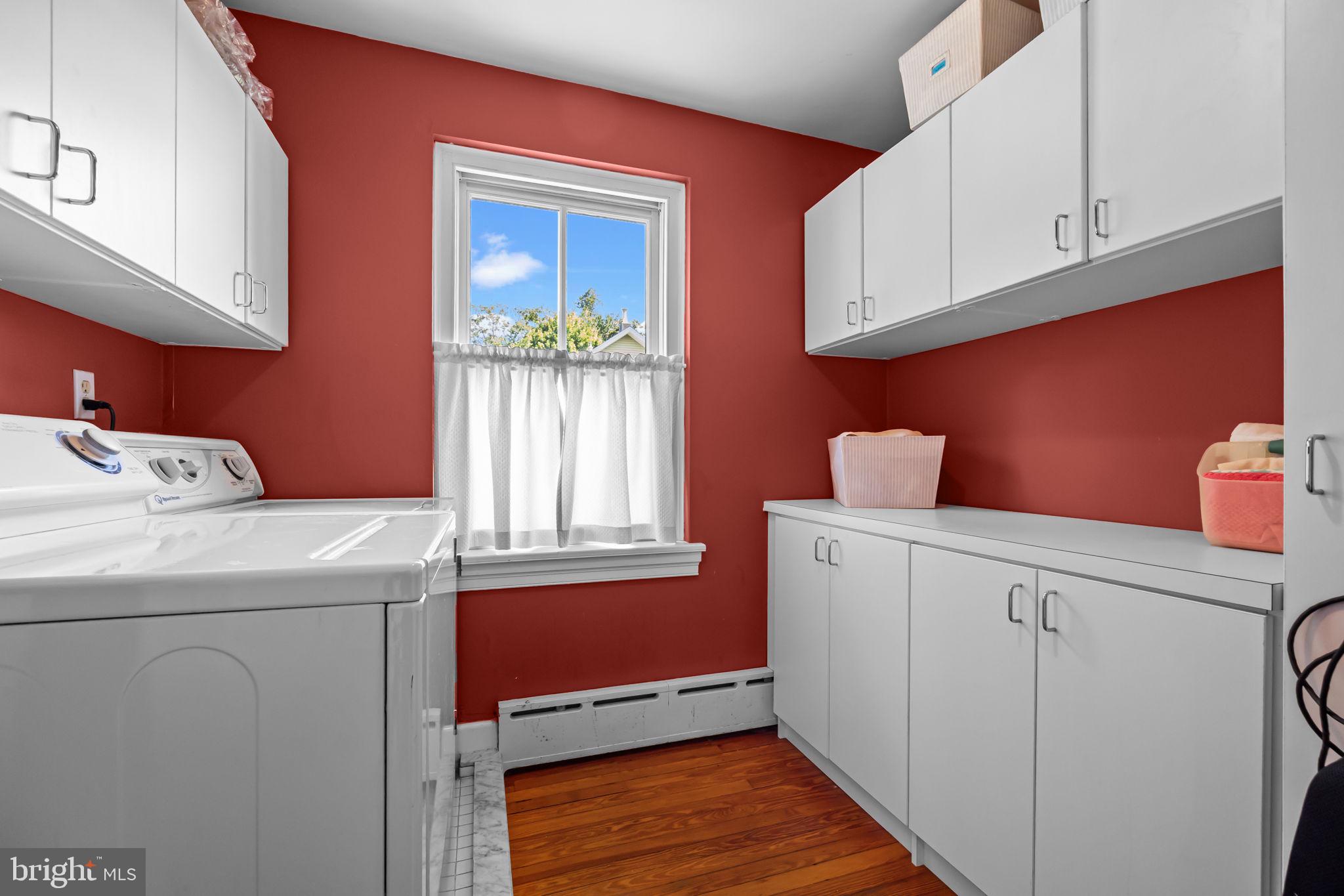 411 East Mill Road Flourtown, PA 19031 - Photo 39 of 62 a utility room with cabinets washer and dryer