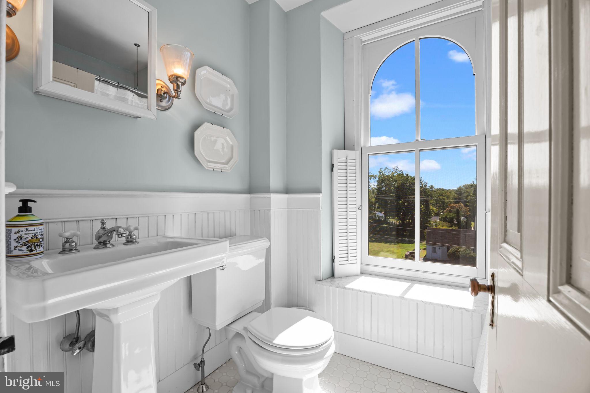 411 East Mill Road Flourtown, PA 19031 - Photo 45 of 62 a bathroom with a toilet a sink vanity and a mirror