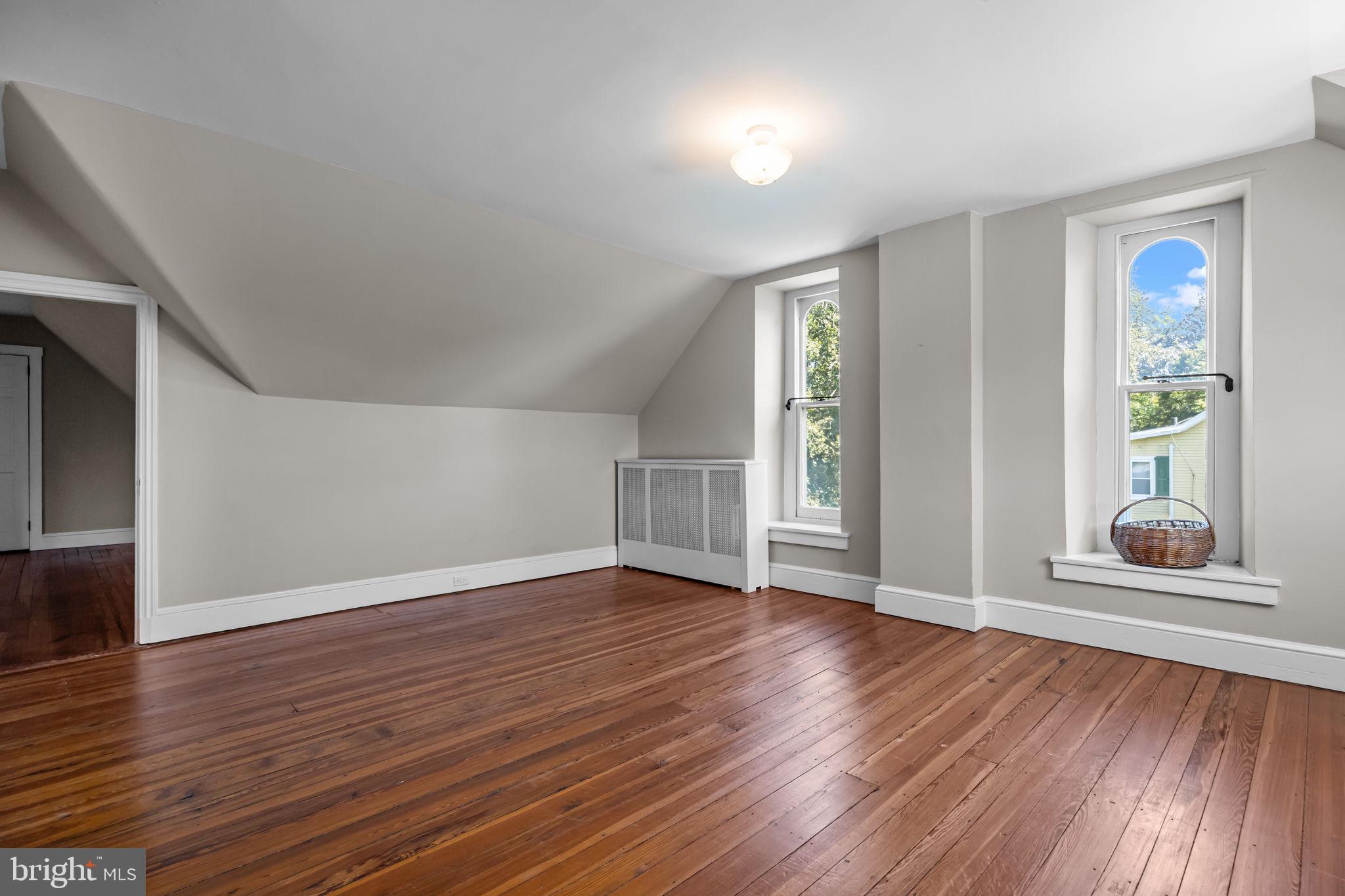 411 East Mill Road Flourtown, PA 19031 - Photo 46 of 62 an empty room with wooden floor and windows
