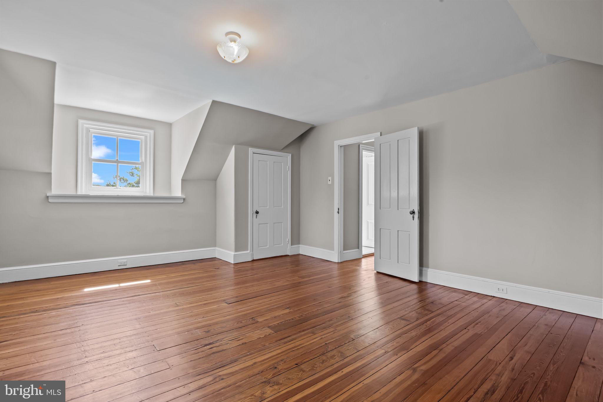 411 East Mill Road Flourtown, PA 19031 - Photo 47 of 62 an empty room with wooden floor and windows