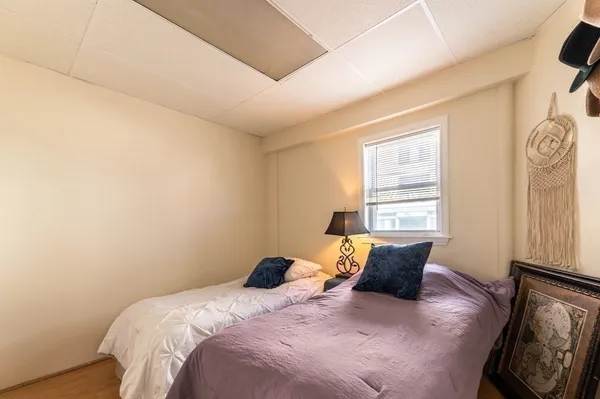 a bed sitting in a bedroom next to a window