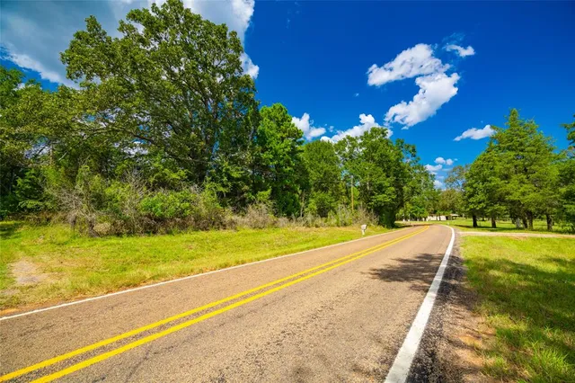 a view of a yard with an empty space and deck area