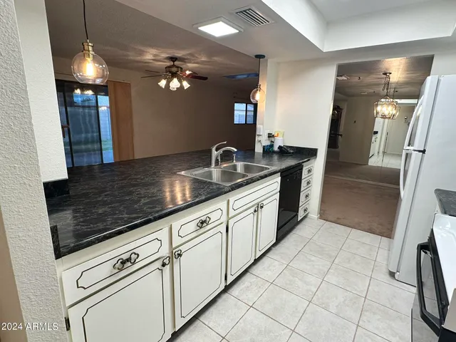 a kitchen with granite countertop a sink and cabinets