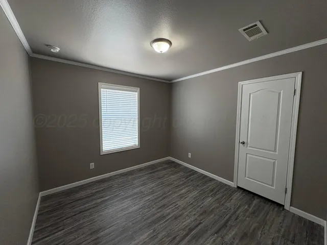 a view of room with window and hardwood floor