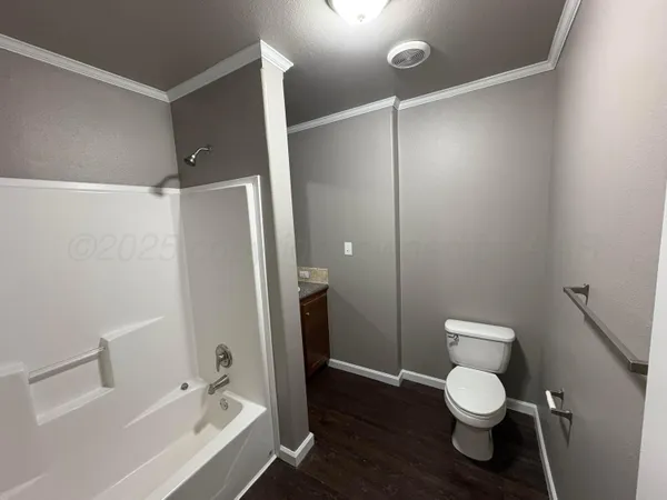 a bathroom with a toilet and a shower