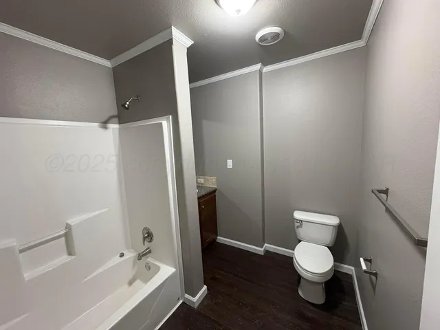 a bathroom with a toilet and a shower