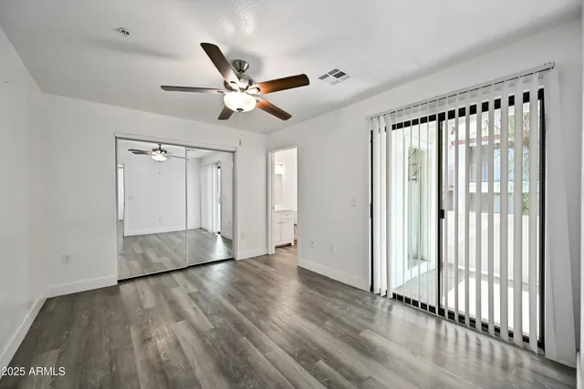 a kitchen that has a sink a stove and wooden floor