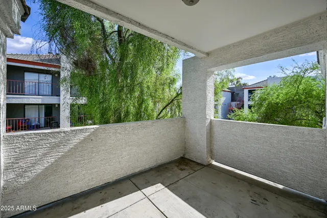 a view of an empty room and wooden floor