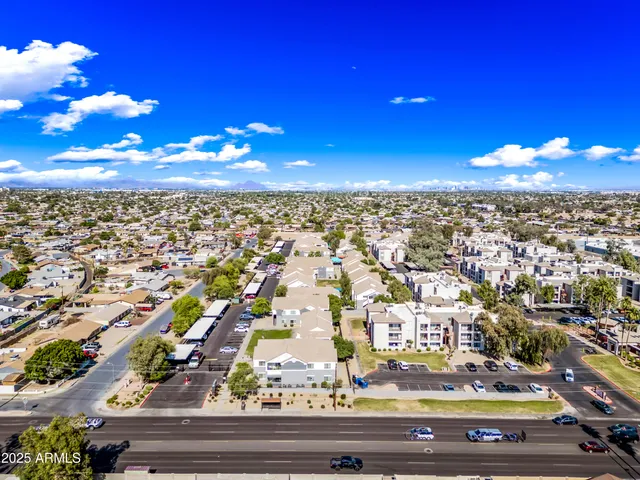 an aerial view of residential houses with city view