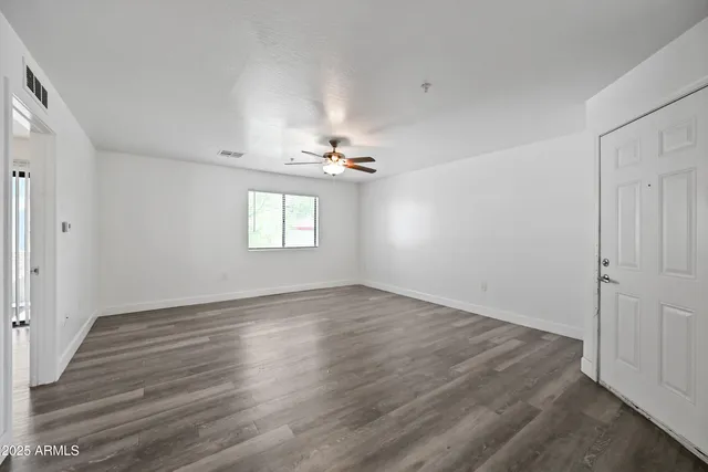 a view of wooden floor and windows in a room