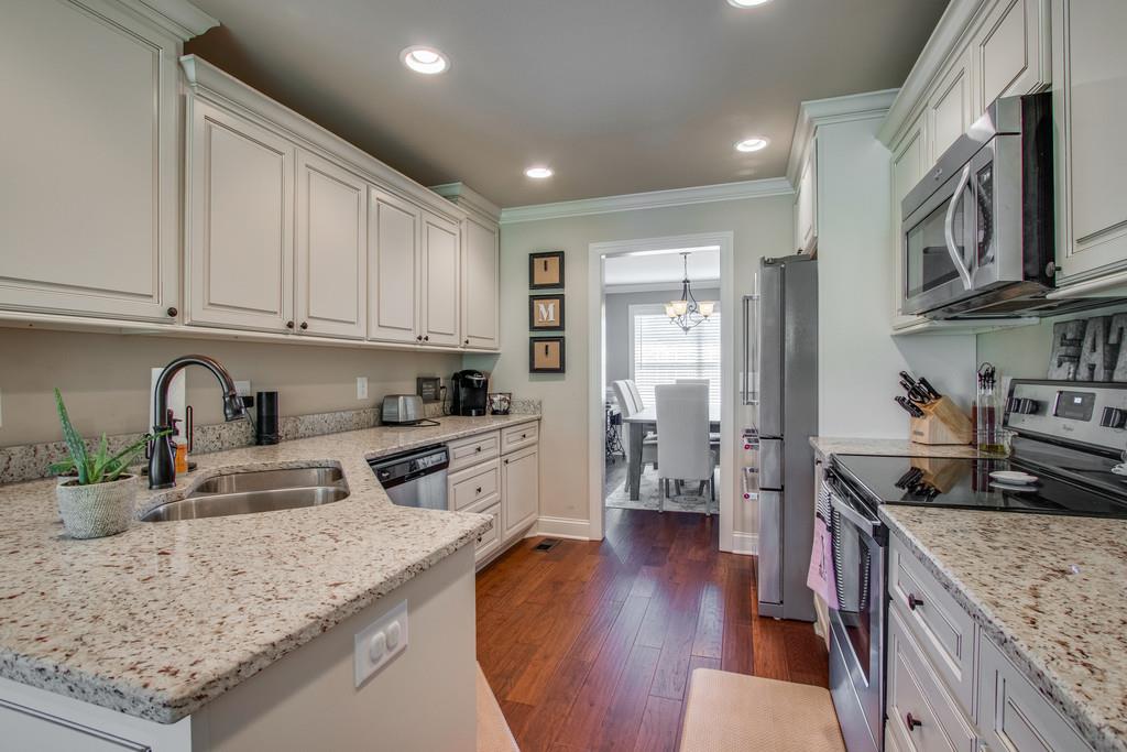 11 Remington Road Lebanon, TN 37090 - Photo 13 of 29 a kitchen with granite countertop a stove top oven a sink a counter space and cabinets