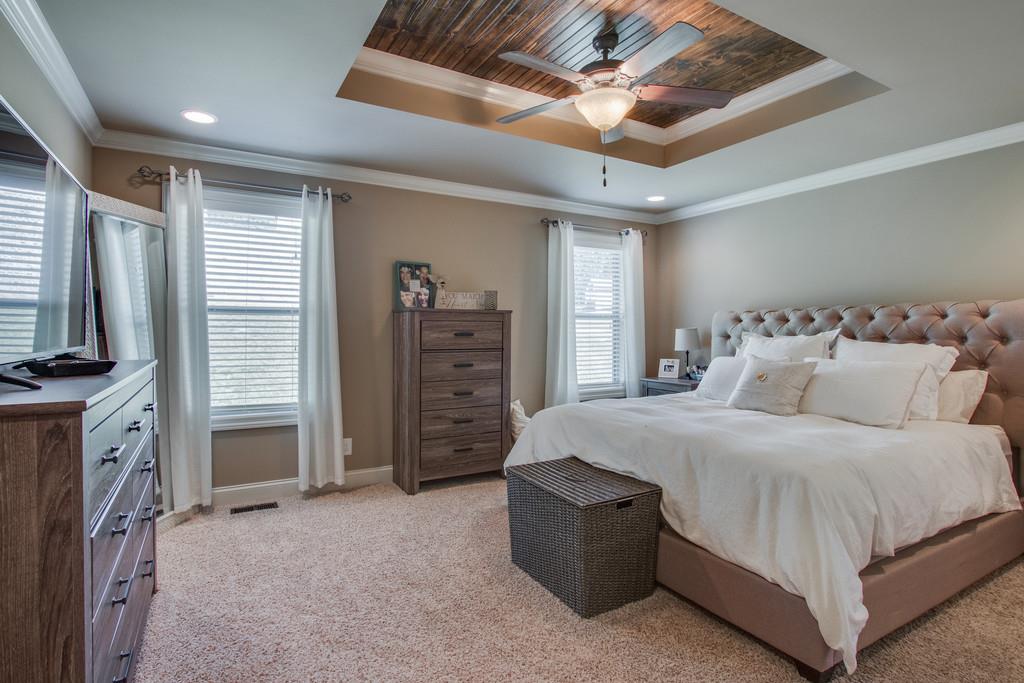 11 Remington Road Lebanon, TN 37090 - Photo 16 of 29 a spacious bedroom with a bed and a flat screen tv