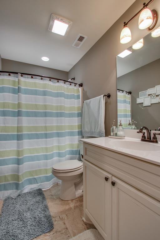 11 Remington Road Lebanon, TN 37090 - Photo 21 of 29 a bathroom with a sink a toilet a shower and vanity