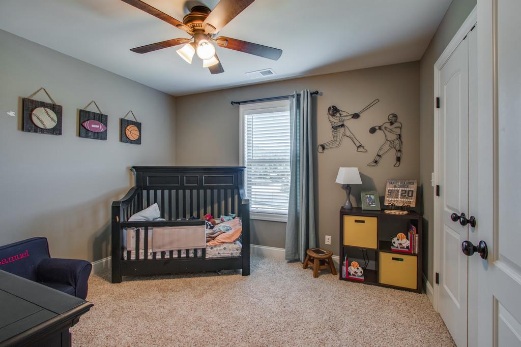 11 Remington Road Lebanon, TN 37090 - Photo 22 of 29 a bedroom with bed and a chandelier