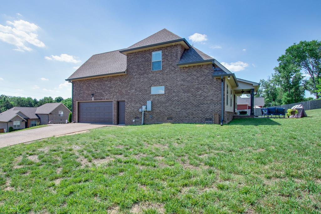 11 Remington Road Lebanon, TN 37090 - Photo 28 of 29 a brick house with a yard and plants