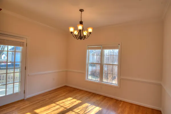 a view of a chandelier in big room and chandelier fan