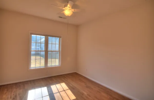 a view of an empty room and wooden floor