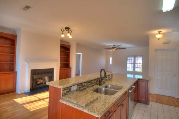 a kitchen with sink cabinets and a wooden floor