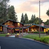 a front view of a house with a yard table and chairs