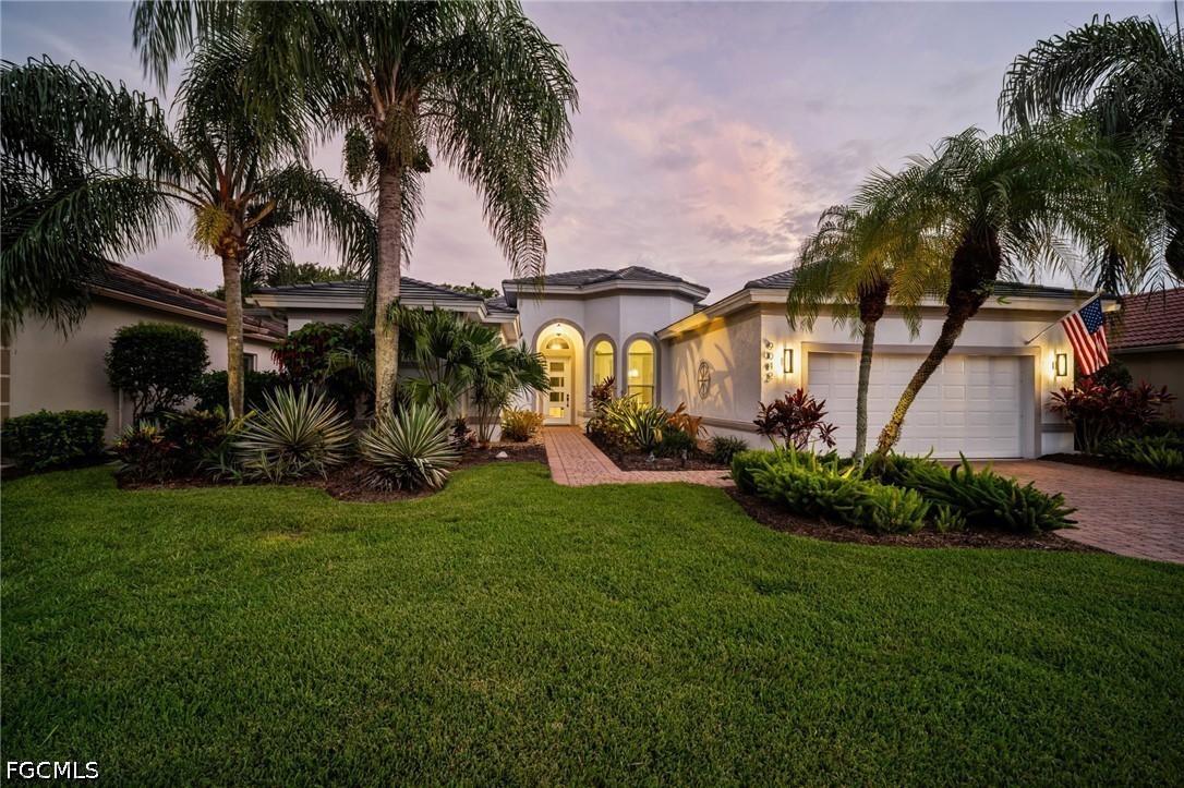 9042 Bronco Court Naples, FL 34113 - Photo 1 of 50 a view of a patio with table and chairs potted plants and palm tree