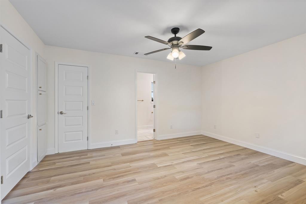 403 East 8th Street Prosper, TX 75078 - Photo 12 of 34 an empty room with wooden floor fan and windows