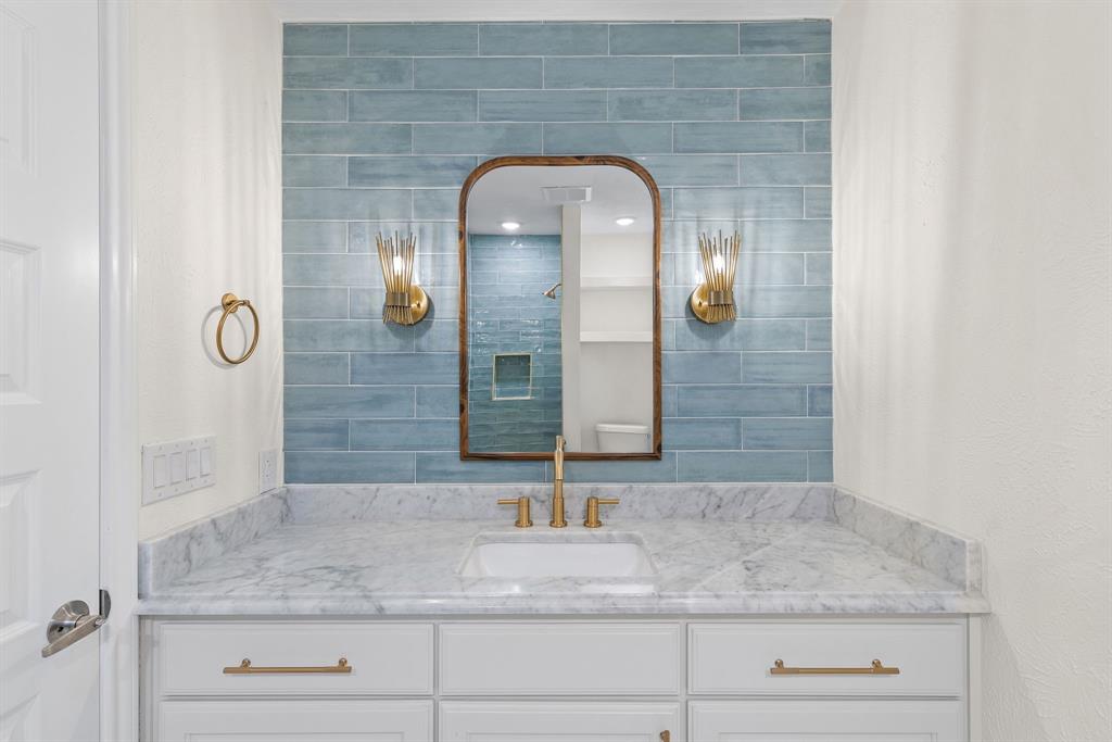 403 East 8th Street Prosper, TX 75078 - Photo 14 of 34 a bathroom with a sink and a mirror