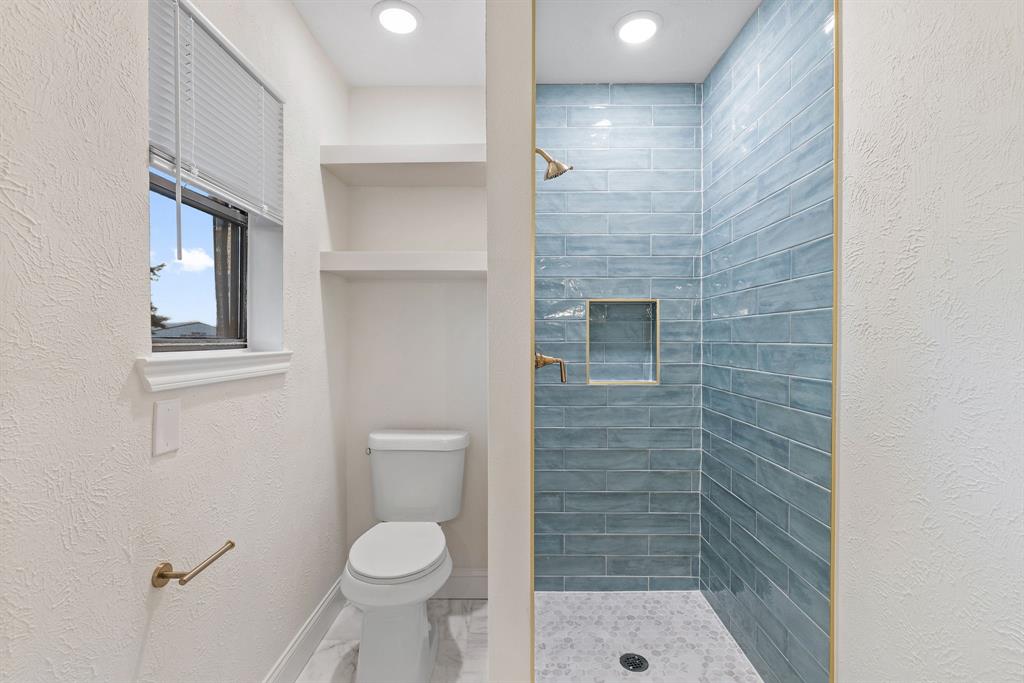 403 East 8th Street Prosper, TX 75078 - Photo 15 of 34 a bathroom with a toilet and a shower