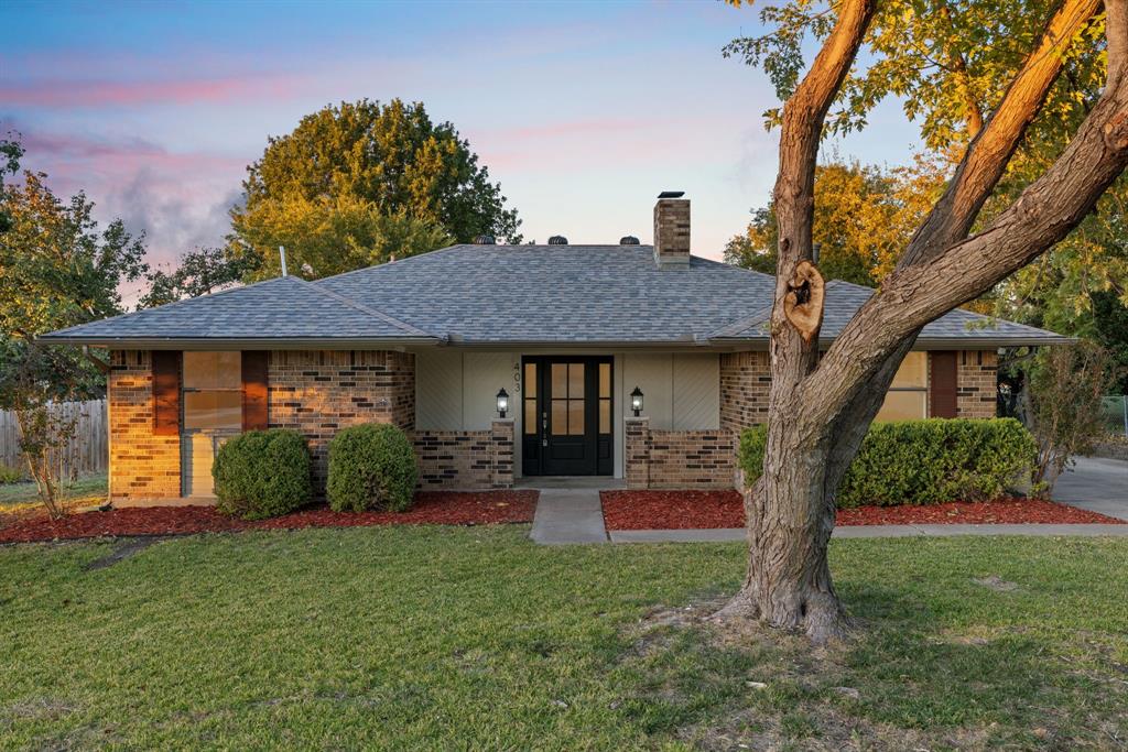 403 East 8th Street Prosper, TX 75078 - Photo 2 of 34 a front view of a house with a garden and plants