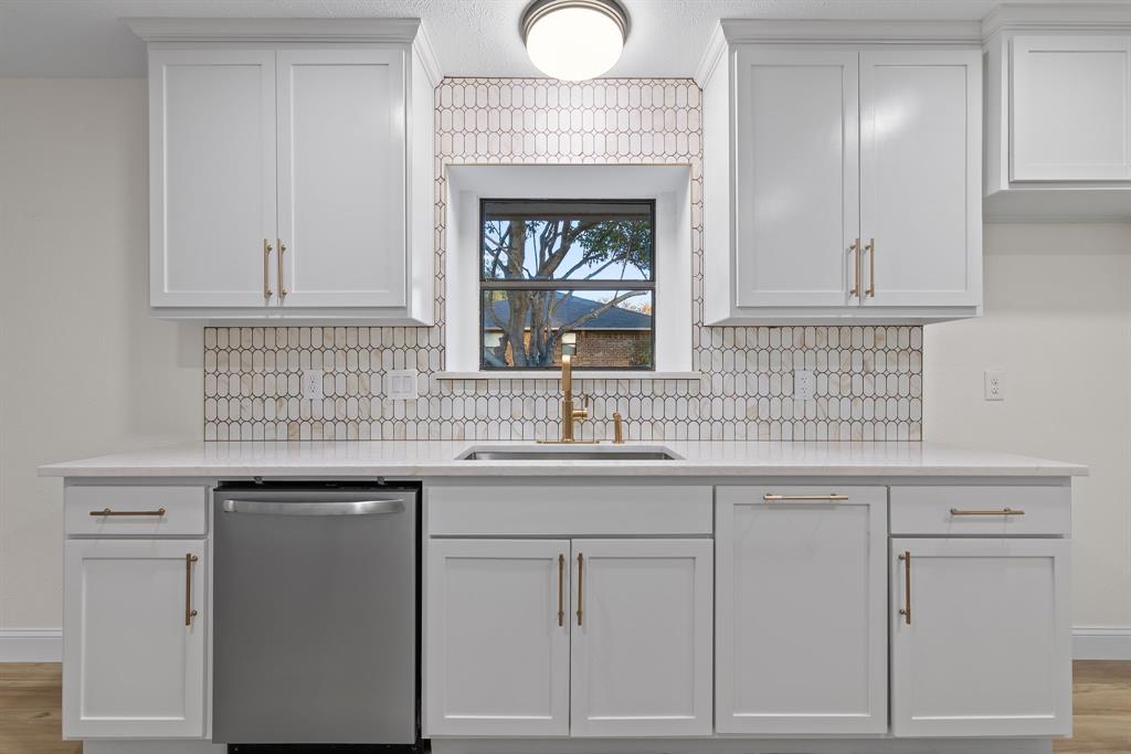 403 East 8th Street Prosper, TX 75078 - Photo 6 of 34 a kitchen with white cabinets and a sink