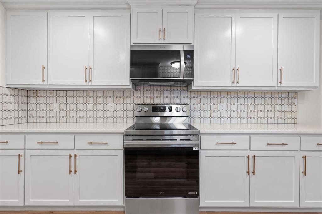 403 East 8th Street Prosper, TX 75078 - Photo 7 of 34 a kitchen with white cabinets and appliances