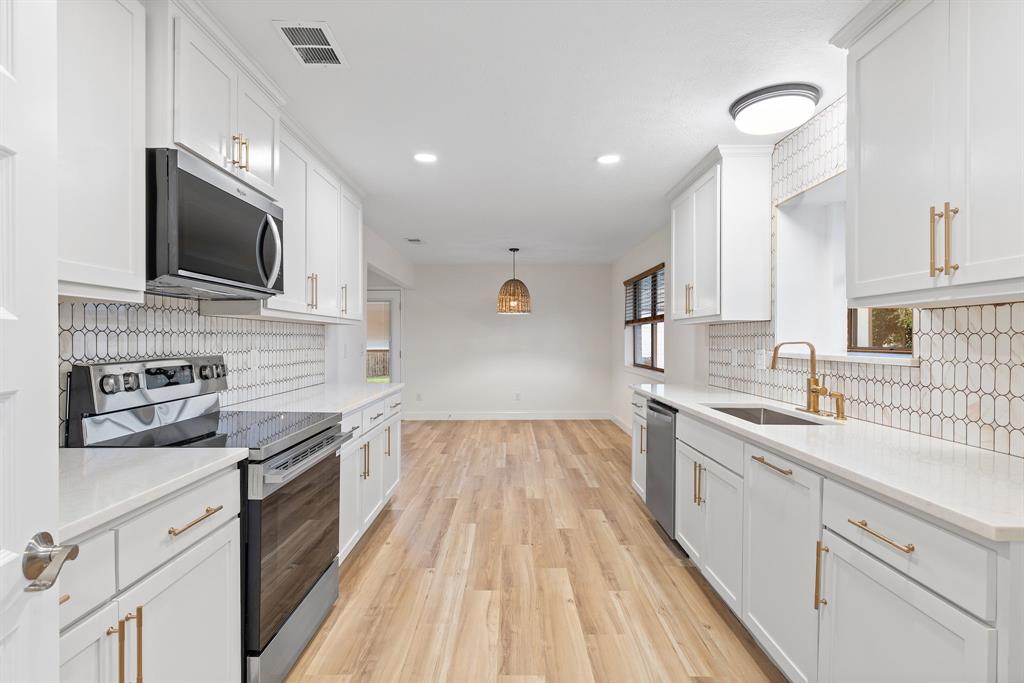 403 East 8th Street Prosper, TX 75078 - Photo 8 of 34 a kitchen with a sink stainless steel appliances and cabinets