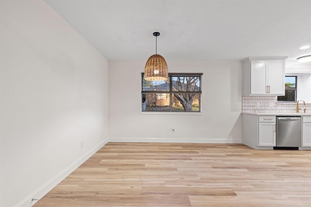 403 East 8th Street Prosper, TX 75078 - Photo 10 of 34 a view of a kitchen with wooden floor and window