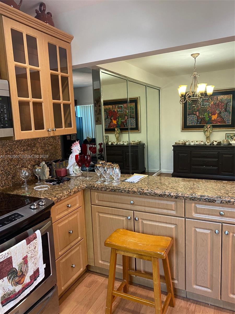 6331 Southwest 17th Street West Miami, FL 33155 - Photo 12 of 42 a kitchen with stainless steel appliances granite countertop a stove a sink and a wooden cabinets