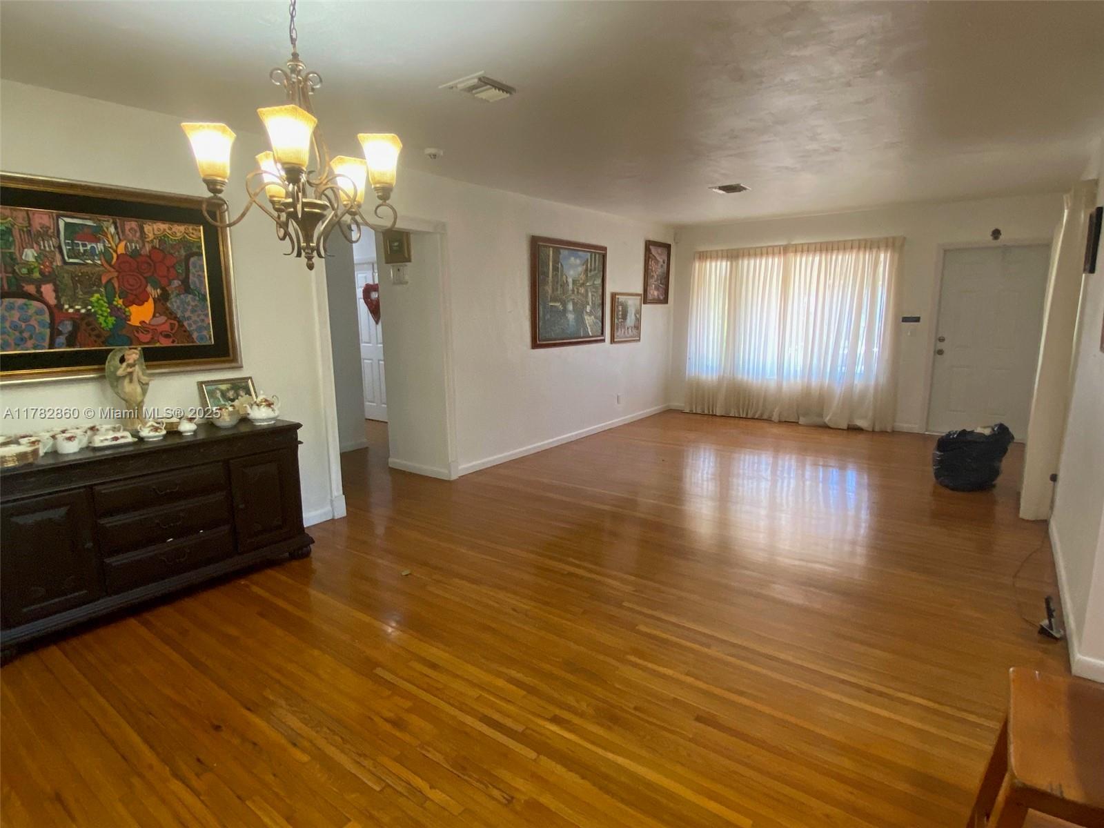 6331 Southwest 17th Street West Miami, FL 33155 - Photo 18 of 42 a view of a living room and kitchen with wooden floor